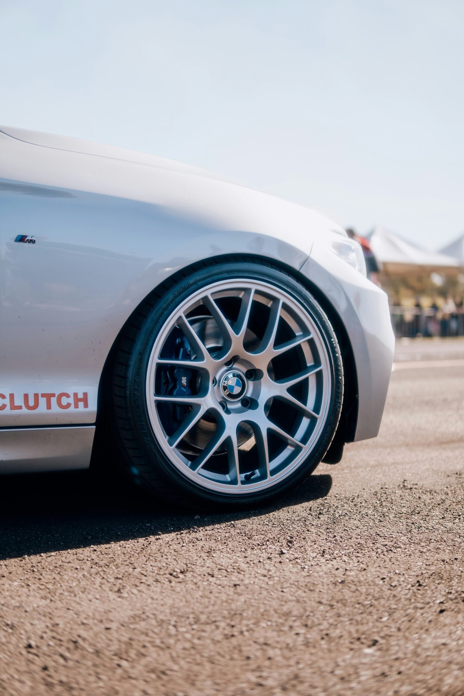 a close up of a white sports car on a road